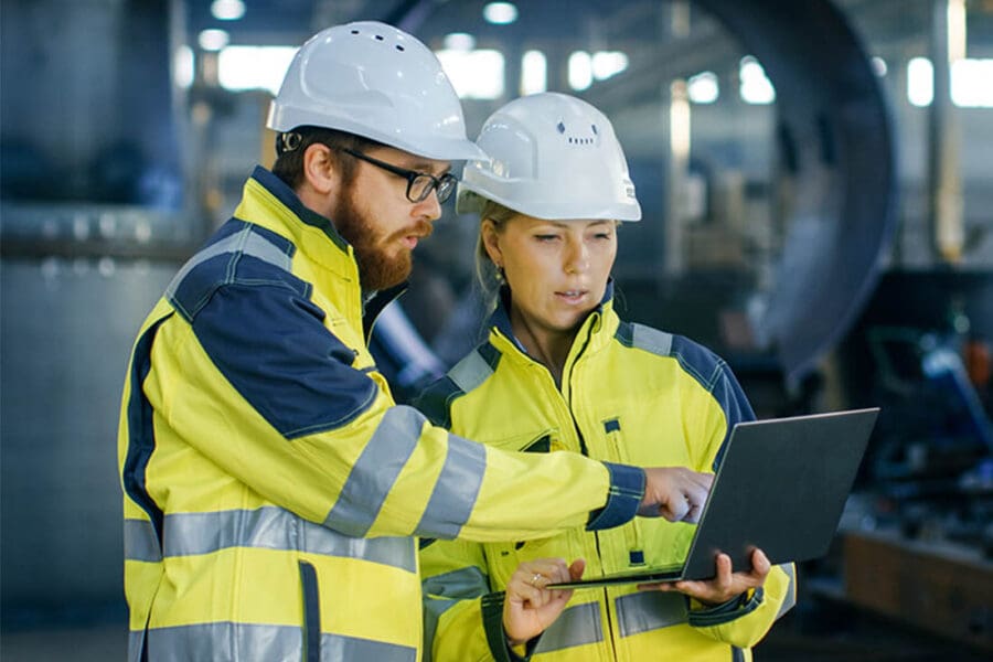 OSHA-Logs-Construction-Crew-with-Hard-Hats-Examaning-a-Tablet
